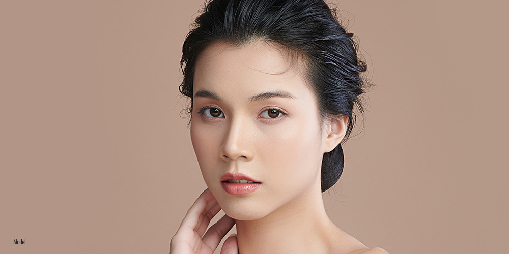 Asian female on light background