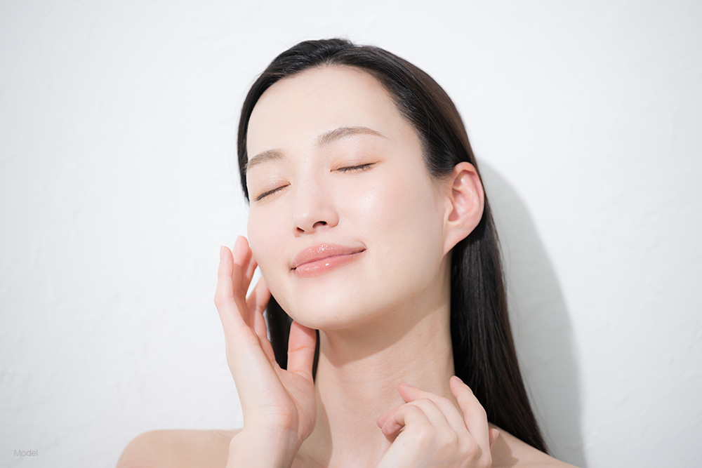 Young asian woman smiling with her eyes closed