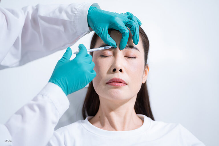 an asian woman getting an injection in her forehead
