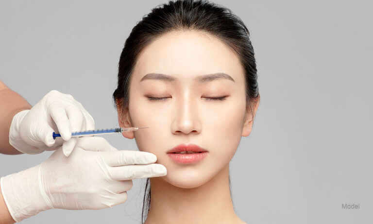 an asian woman getting an injection in her cheeks