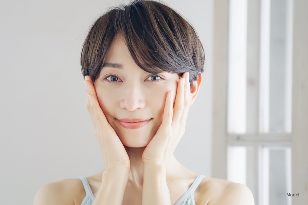 Woman holding her face with both hands